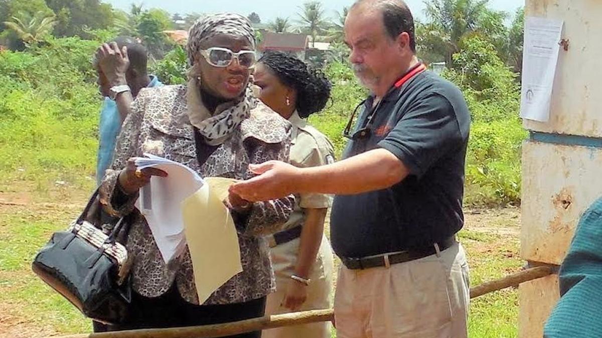 Richard Wilson, a Mercer professor serving as president of the Liberia Baptist Theological Seminary, speaks with the seminary's attorney, Pearl Brown-Bull, about an order to arrest Wilson and close down the school.