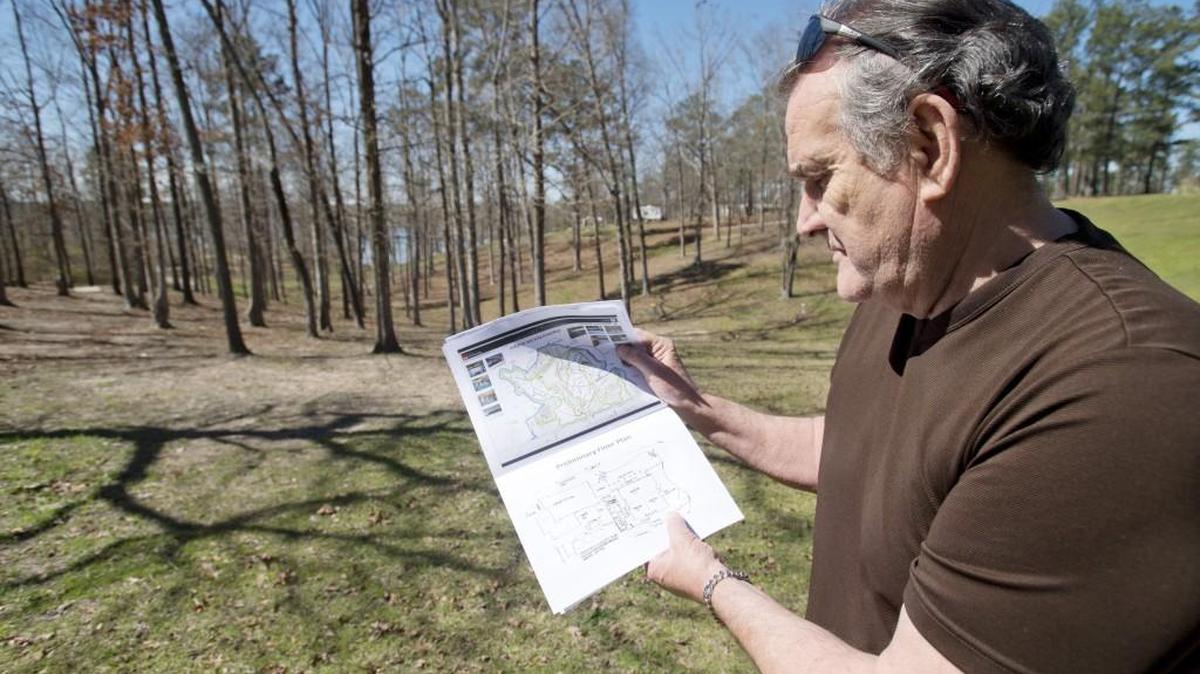 Macon-Bibb County Commissioner Joe Allen shows plan from 2010 to build park ranger offices and meeting space inside Clayton Park at Lake Tobesofkee. A proposal to build a subdivision at the same site was recently presented to the County Commission.