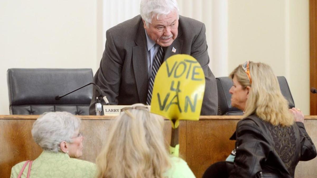 Macon-Bibb County Commissioner Ed DeFore speaks with Van VanDeWalker supporters after a commission committee vote for the animal welfare director on April 16, 2014.