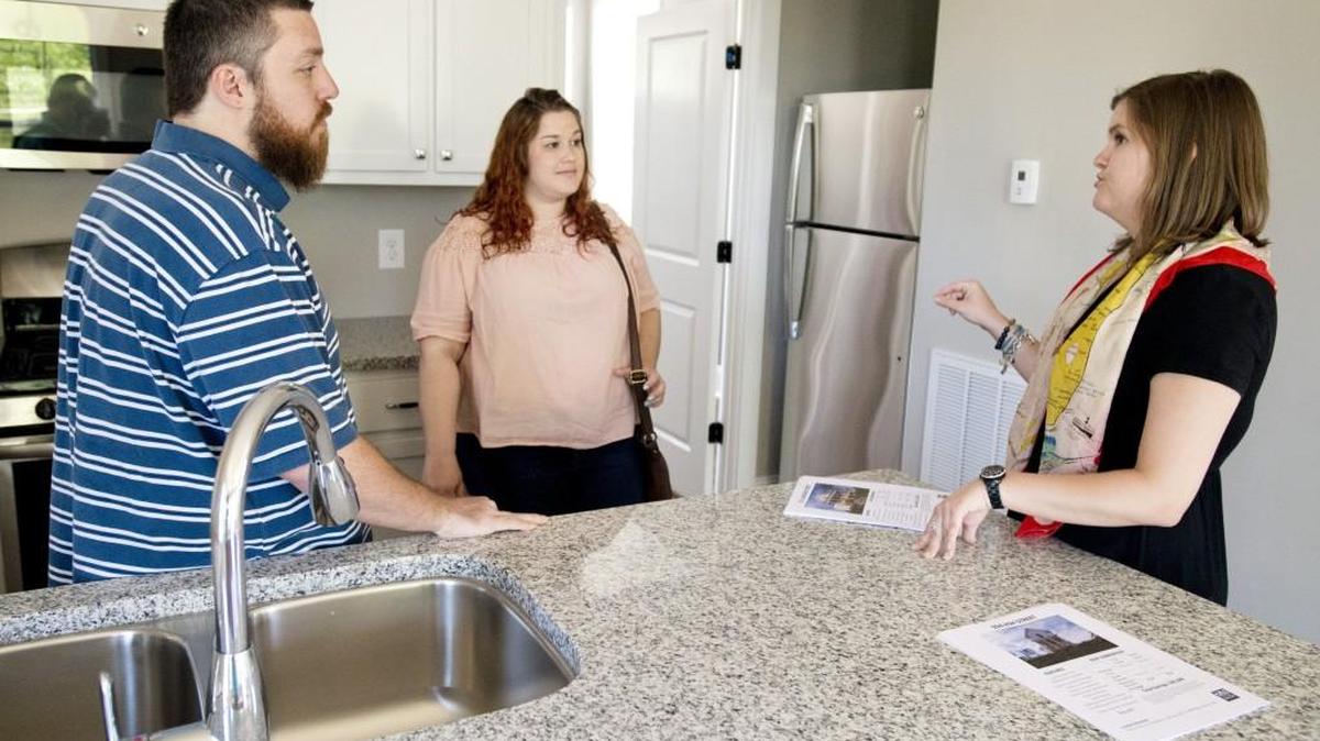Lauren Mauldin, right, with Historic Macon, speaks with Joey Tant and his fiance Heather Comer at 924 Ash Street during a Beall's Hill Open House hosted by the Historic Macon Foundation Sunday.