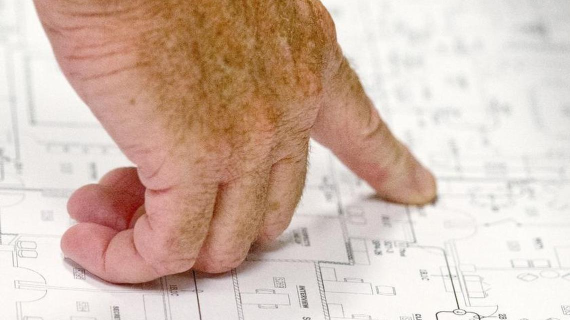 SPLOST Project Manager Clay Murphey looks at blueprints of the upstairs of the future Bibb County Sheriff's Office Annex in the former Sears building on Third Street.