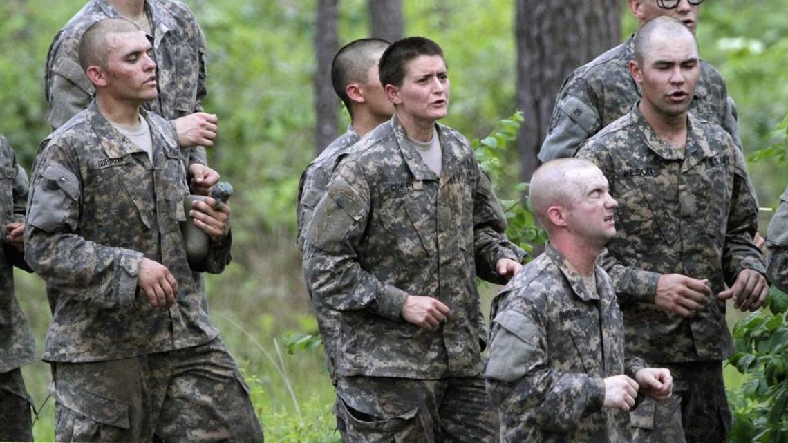 In this April 19, 2015 file photo, one of the 20 female soldiers, center, who is among the 400 students who qualified to start Ranger School, runs in place in between obstacles on the Darby Queen, one of the toughest obstacle courses in U.S. Army training, at Fort Benning, in Georgia.