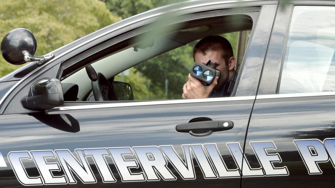 A Centerville police officer uses a infrared laser gun to check for speed violations in this file photo.