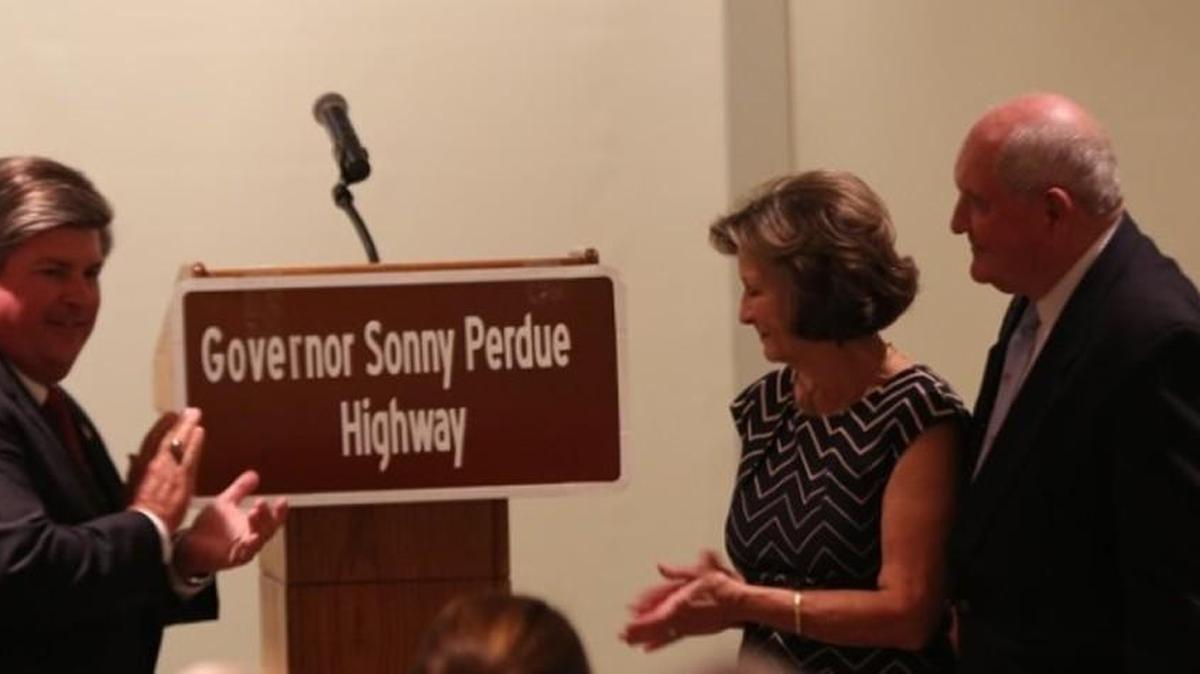 State Sen. Larry Walker III (R-Perry) with former Georgia Gov. Sonny Perdue, far right, and wife Mary Perdue during an Aug. 30, 2016 dedication ceremony. A section of Interstate 75 in Houston County has been named after Perdue.