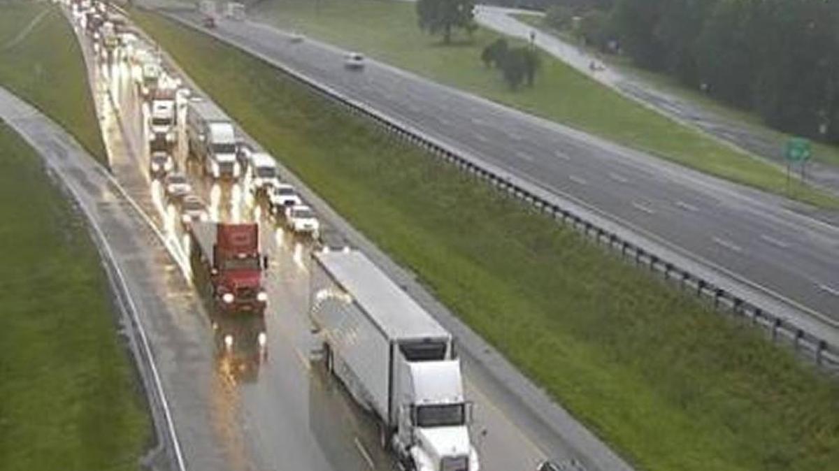 Traffic backed up on Interstate 75 North near Rumble Road after a tractor trailer overturned and lost its load of produce on the side of the highway in Monroe County.