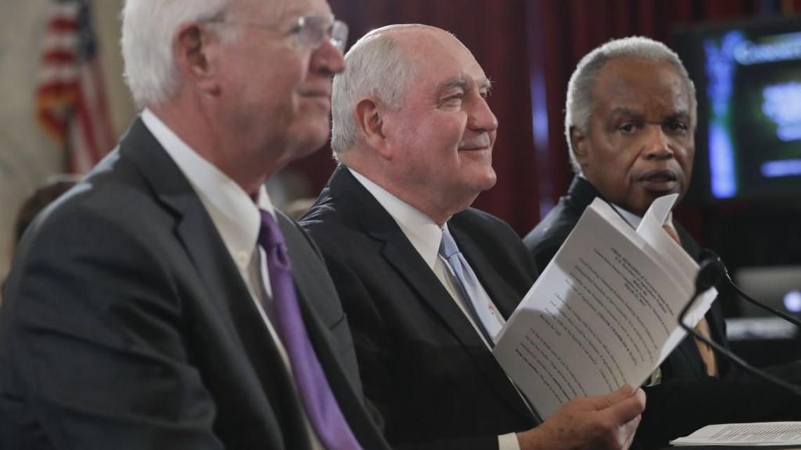 Agriculture Secretary-designate, former Georgia Gov. Sonny Perdue, center, accompanied by former Georgia Sen. Saxby Chambliss, R-Ga., left, and Rep. David Scott, D-Ga., prepares to testify on Capitol Hill in Washington, Thursday, March 23, 2017, at his confirmation hearing before the Senate Agriculture, Nutrition and Forestry Committee.