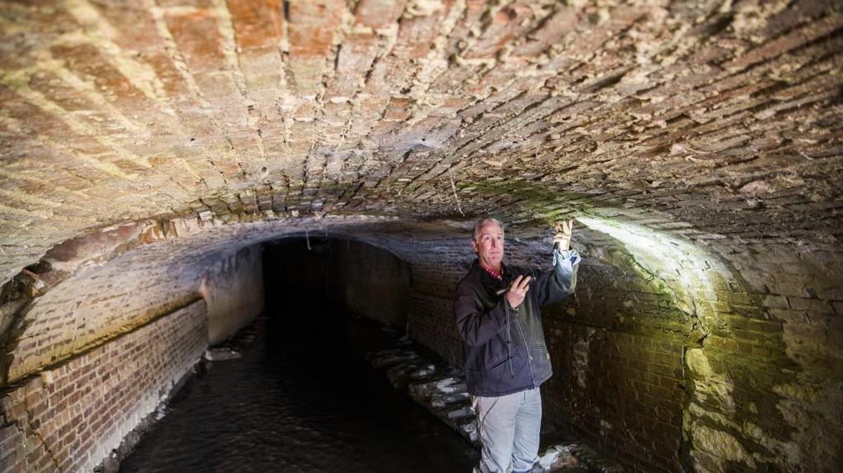 Clay Murphey, program director for special sales tax funded projects in Macon-Bibb County, points out how the stormwater culvert running underneath Second Street and Hazel Street in Macon is in danger of falling in in this February 2016 file photo.