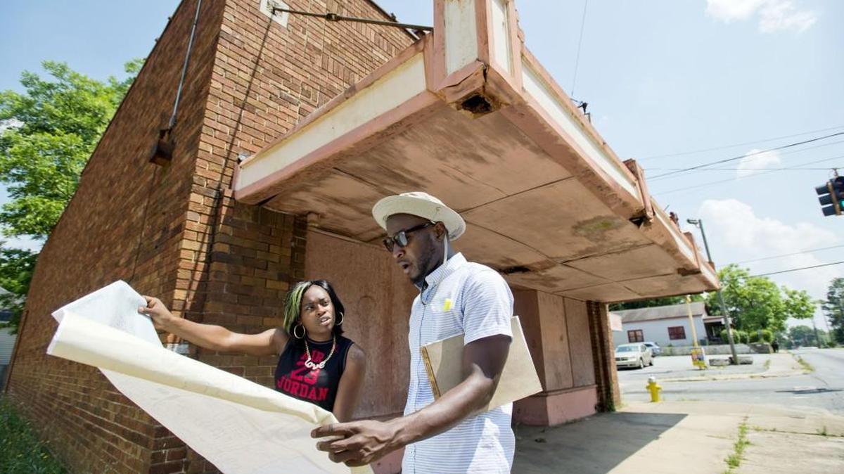 Danny Glover speaks with neighborhood resident Keyarrow Gay in front of the former C&K convenience store at the corner of Second and Ell streets. Glover hopes to create a corporation that oversees neighborhood associations in south Macon.
