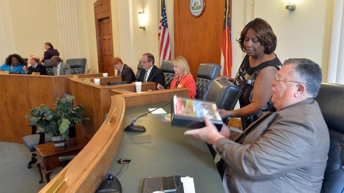 Macon-Bibb County Commissioner Scotty Shepherd, right, receives his copy of the proposed fiscal 2017 budget on May 10, 2016.