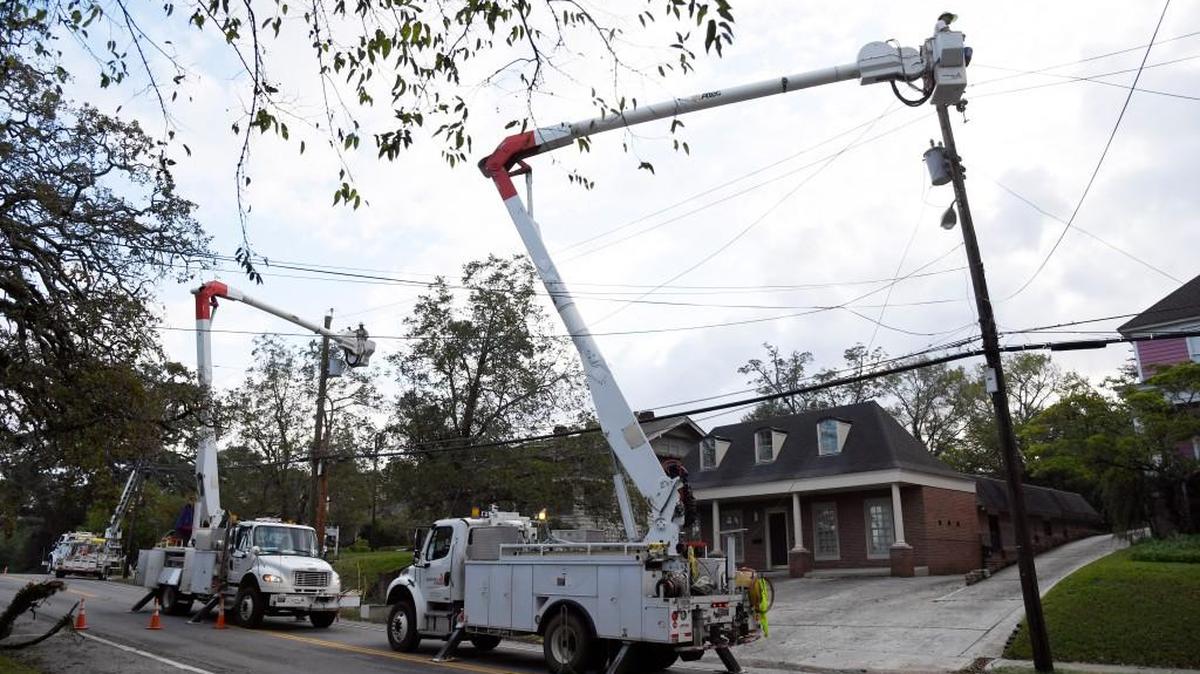 A Georgia Power crew works to repair power lines on Pierce Avenue near Vineville Avenue Wednesday morning.
