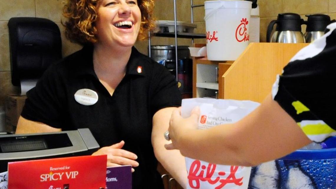 Regina Bodenheimer, cashier at the Chick-fil-A on Tom Hill Sr. Boulevard, serves a spicy chicken sandwich in this June 2, 2010, file photo.