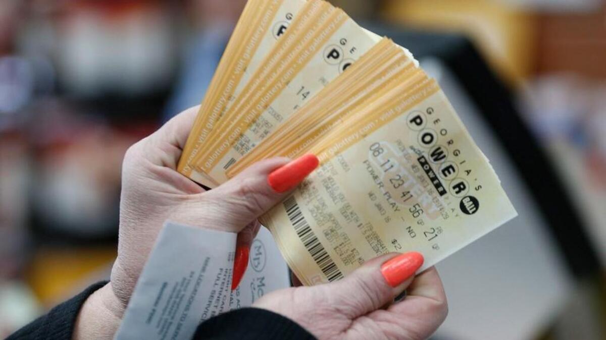 A lottery player displays Powerball lottery tickets at a Pilot convenience store, Wednesday, Jan. 13, 2016, in Tallapoosa, Georgia, in this AP file photo.