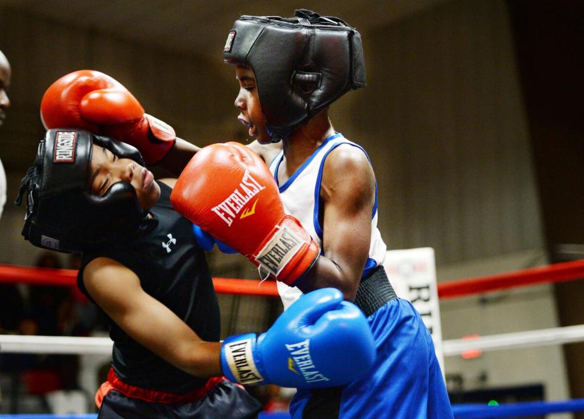 Joshua Fontenot III, right, of the Macon-Bibb United Boxing Club lands a punch on Cordova Hall during an exhibition at the Freedom Park gym Saturday. It was was Fontenot’s first bout as a boxer.