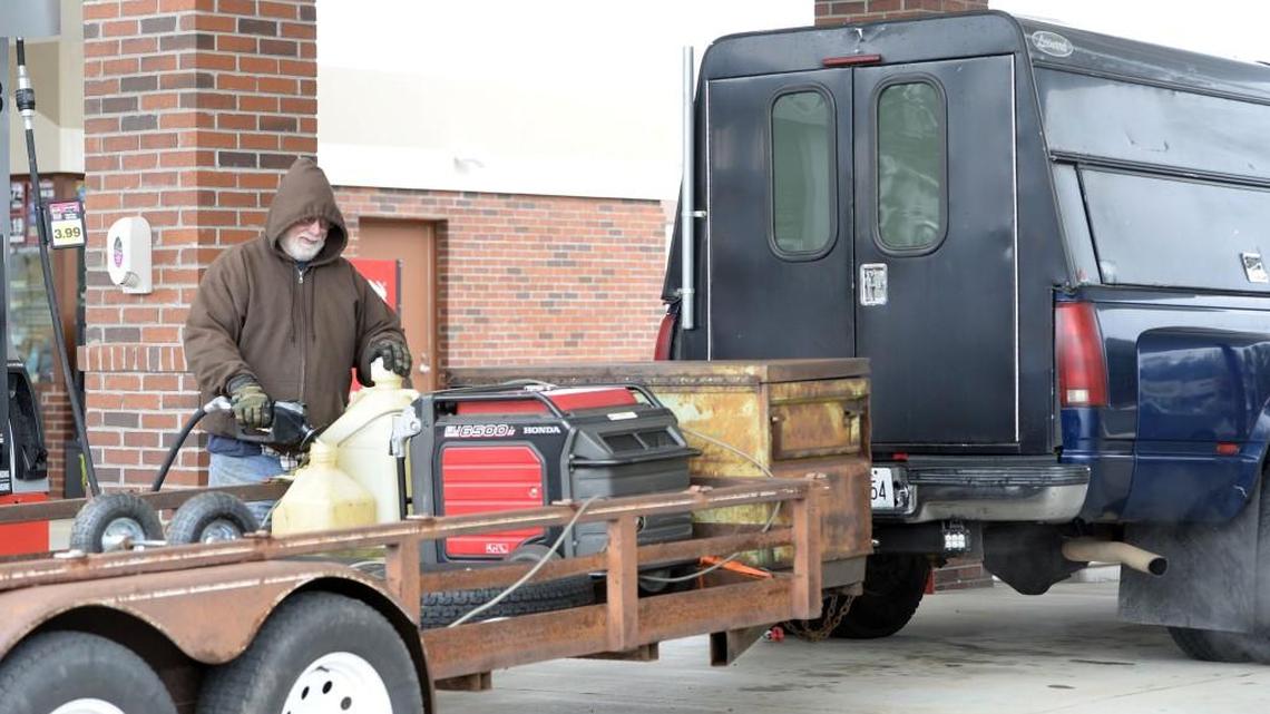 Albert Hawkins endures the cold weather Saturday morning at Kroger in south Bibb County, where he filled his truck — and several spare tanks — with fuel. “I’m heading for Iowa where it’s a lot colder than this,’’ Hawkins said. He was packing a generator to power a heater in the back of his big truck, where he expected to ride out the cold while on a business trip.