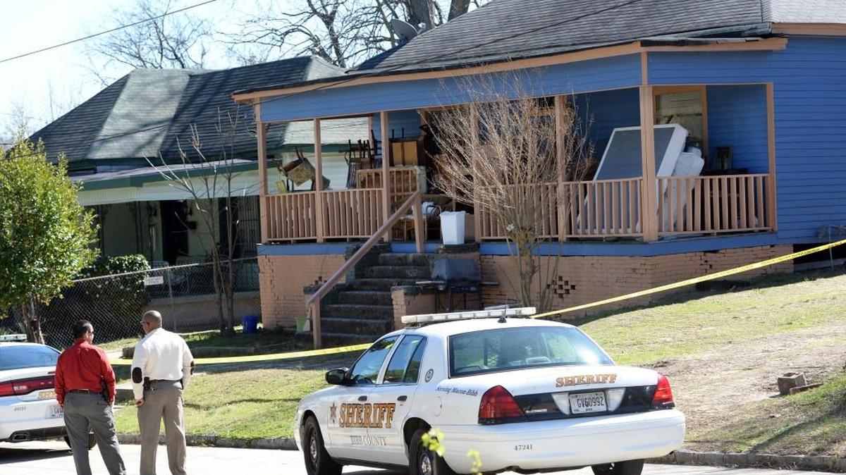 Bibb Sheriff's deputies wait outside a home on First Ave. for a search warrant after discovering a body, in this February 2017 file photo.