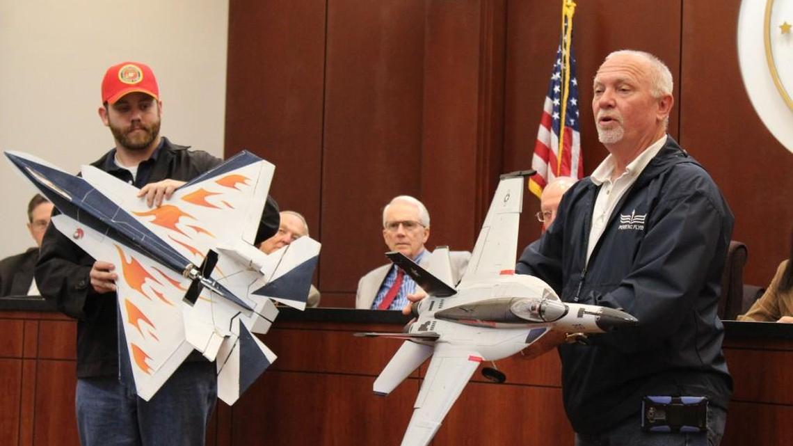 Adam Hamilton, left, and Dave Morrison, members of the Perry RC Flyers, show model planes at the Houston County Commission meeting Nov. 15. They are seeking a piece of land where they can fly the planes.