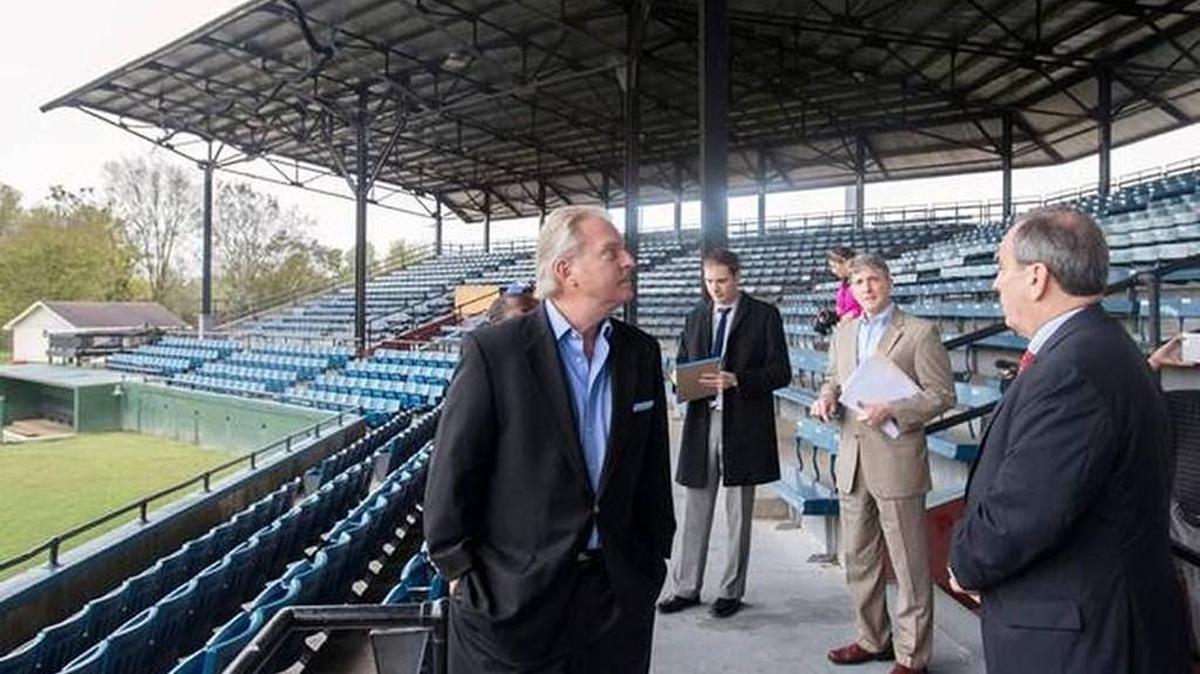 Macon-Bibb County Mayor Robert Reichert, right, speaks with representatives from B&D Venues inside Luther Williams Field in 2015. The ball field could now become the home of a summer collegiate baseball team.