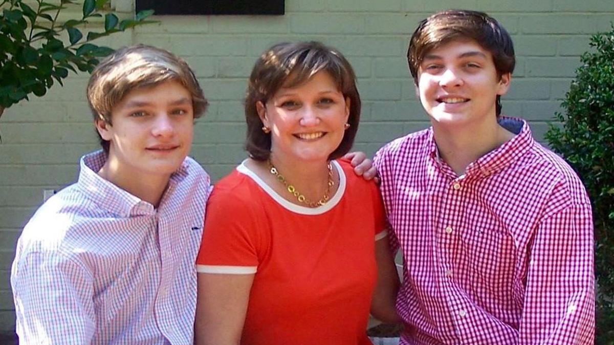 Molly Muse sits with her sons Matt, left, and Beck.