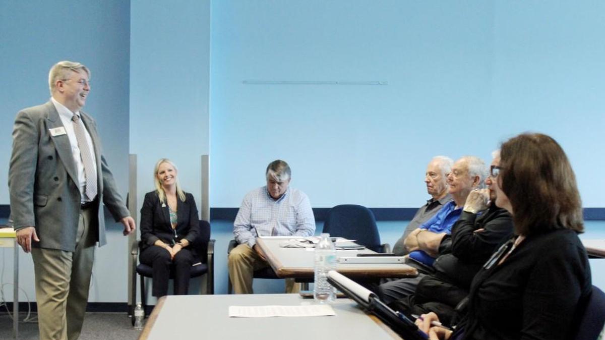 Dan Rhoades, the 21st Century Partnership's director of strategy, talks to members at a meeting Tuesday at the Museum of Aviation.