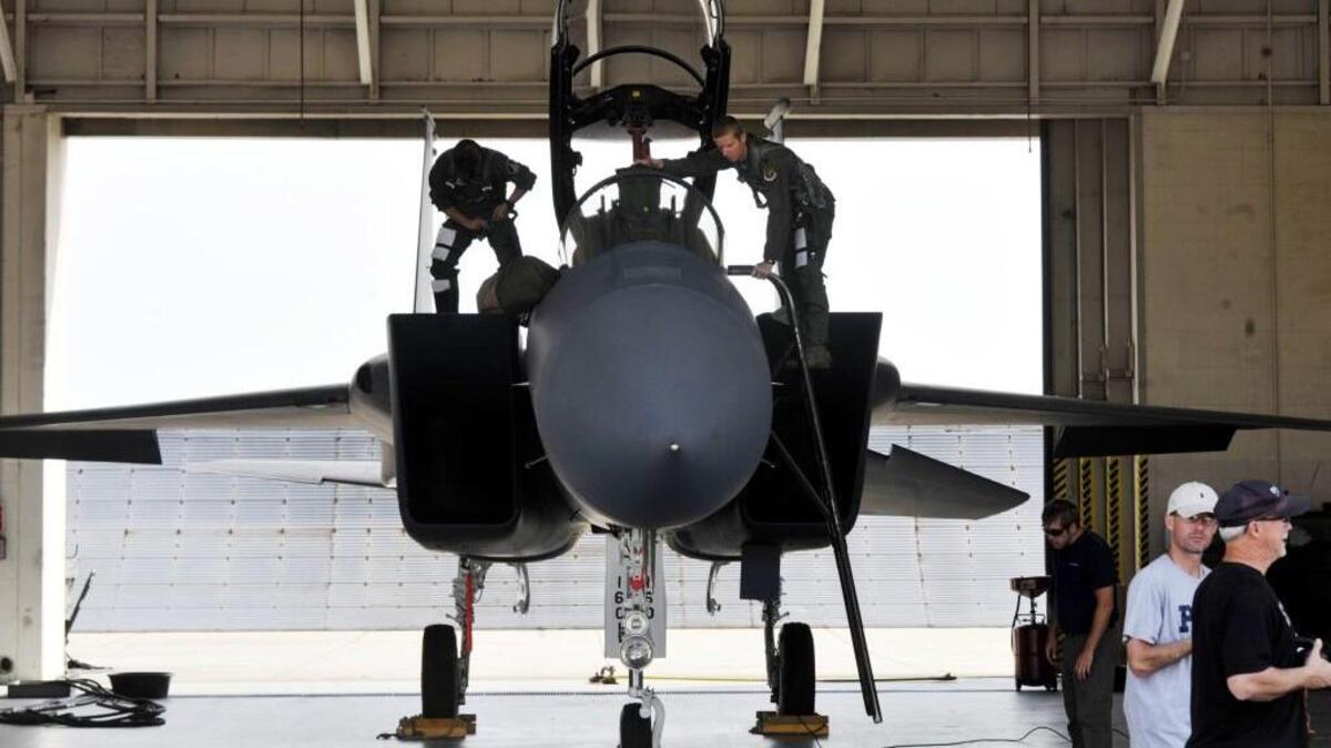 Lt. Col. Chris Coddington, right, and Lt. Col. Rick Sposato, left, prepare for a training flight on April 17, 2013 at Robins Air Force Base. Robins F-15 pilots will conduct a flyover of the Cherry Blossom Festival on Sunday, will do a second practice run Thursday.