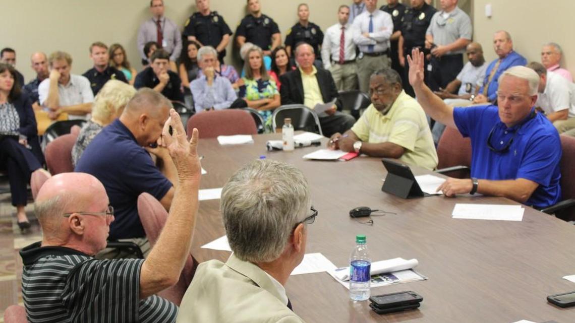 Warner Robins councilmen Mike Davis, left, and Keith Lauritsen cast their votes in favor of the proposed budget Thursday. Moments later, Councilwoman Carolyn Robbins also cast her vote in favor.