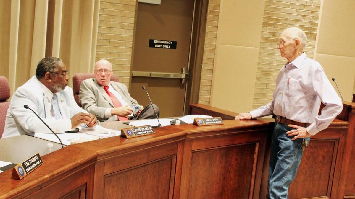 Former Warner Robins City Council member John Williams, right, speaks with councilmen Clifford Holmes, left, and Mike Davis prior to Monday's meeting.