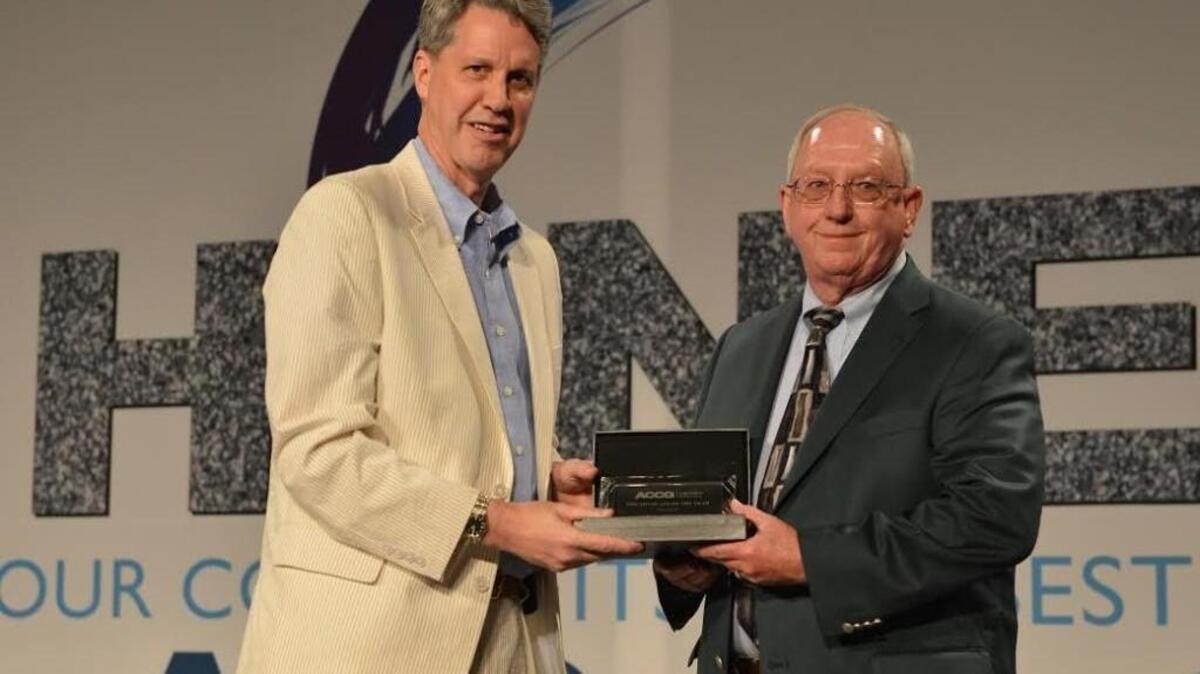 Ross King, executive director of the Association County Commissioners of Georgia, presents Houston County Commission Chairman Tommy Stalnaker with the group's award for Legislative Advocate of the Year.