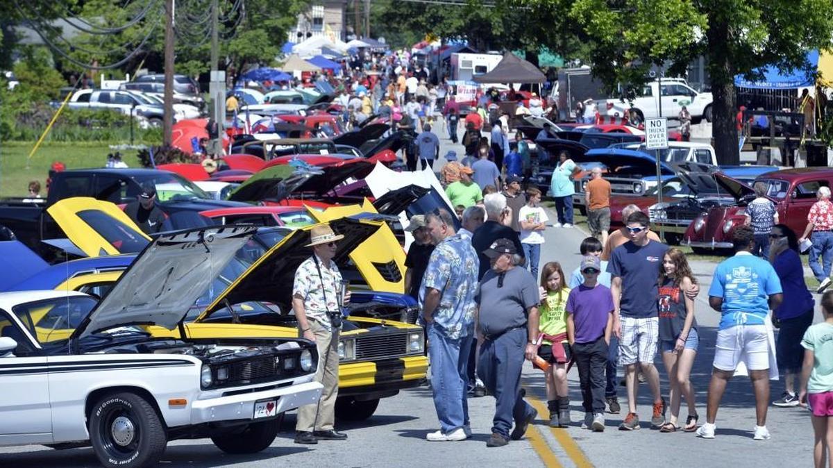 The classic car cruise-in attracted crowds at least as big as the food vendors Saturday at the Battle of Byron Saturday. Calvin Hyer, left, showed off his white Plymouth Duster and suggested the reason for the big interest was probably that there were more cars than ever and a lot of different models people rarely see.