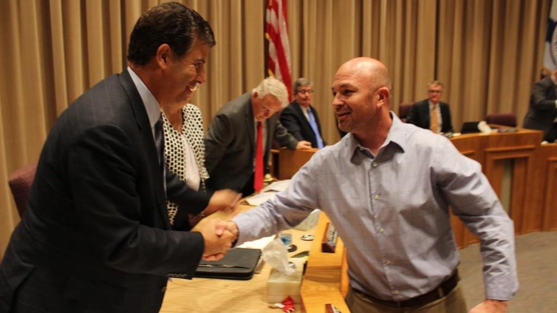 Warner Robins Councilman Chuck Shaheen, left, congratulates Jarred Reneau after Reneau was named the city’s new recreation director.