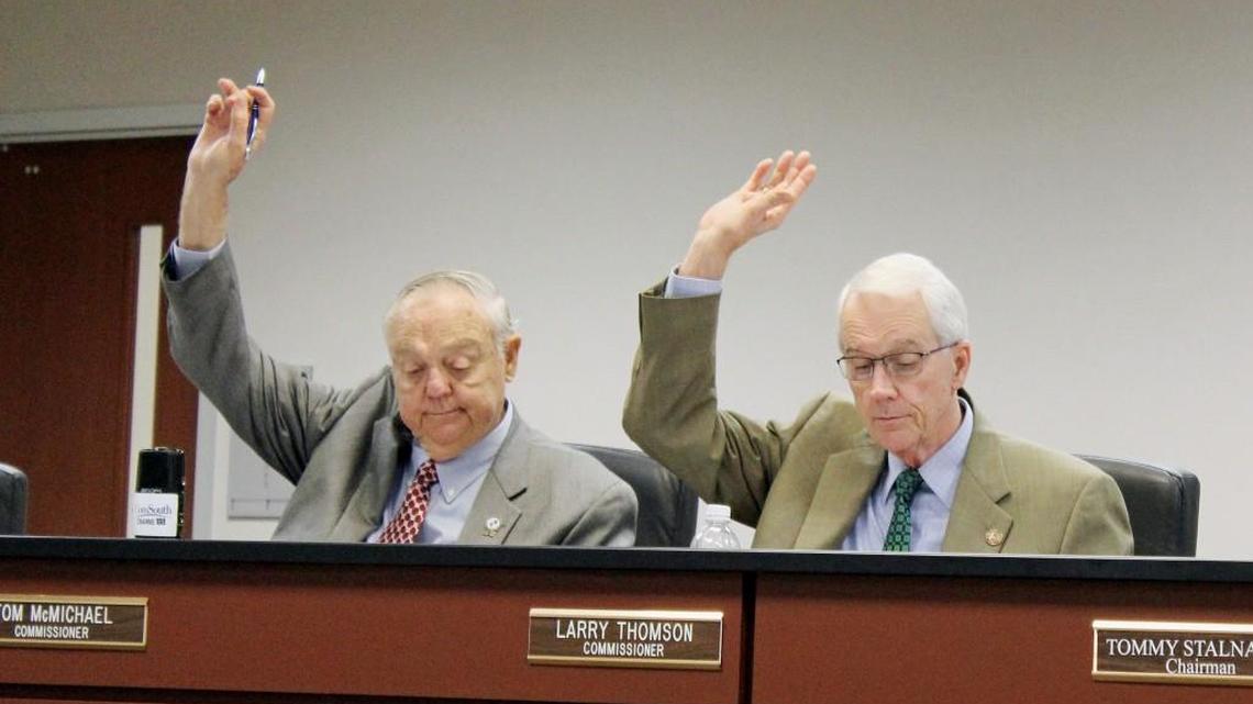 Houston County commissioners Tom McMichael, left and Larry Thomson cast their votes at Tuesday's meeting in favor of an ordinance requiring a permit to cut timber.