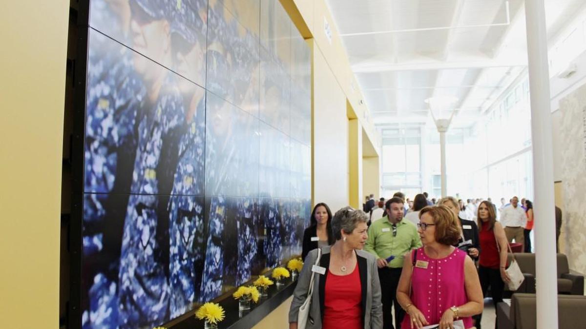 Attendees walk through the Veterans Education Career Transition Resource Center after the ribbon cutting on Aug. 2, 2016. The center is celebrating one year of operation with an open house on Wednesday.