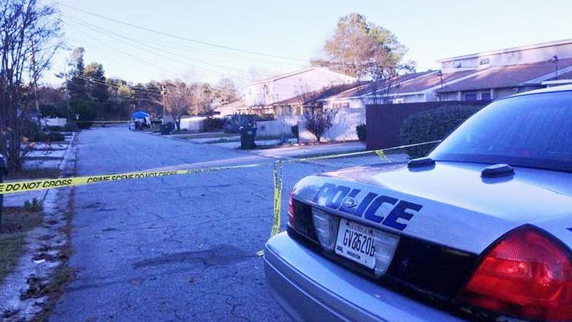 A police car and crime scene tape block off an area of Villa Court North on Saturday following a homicide.