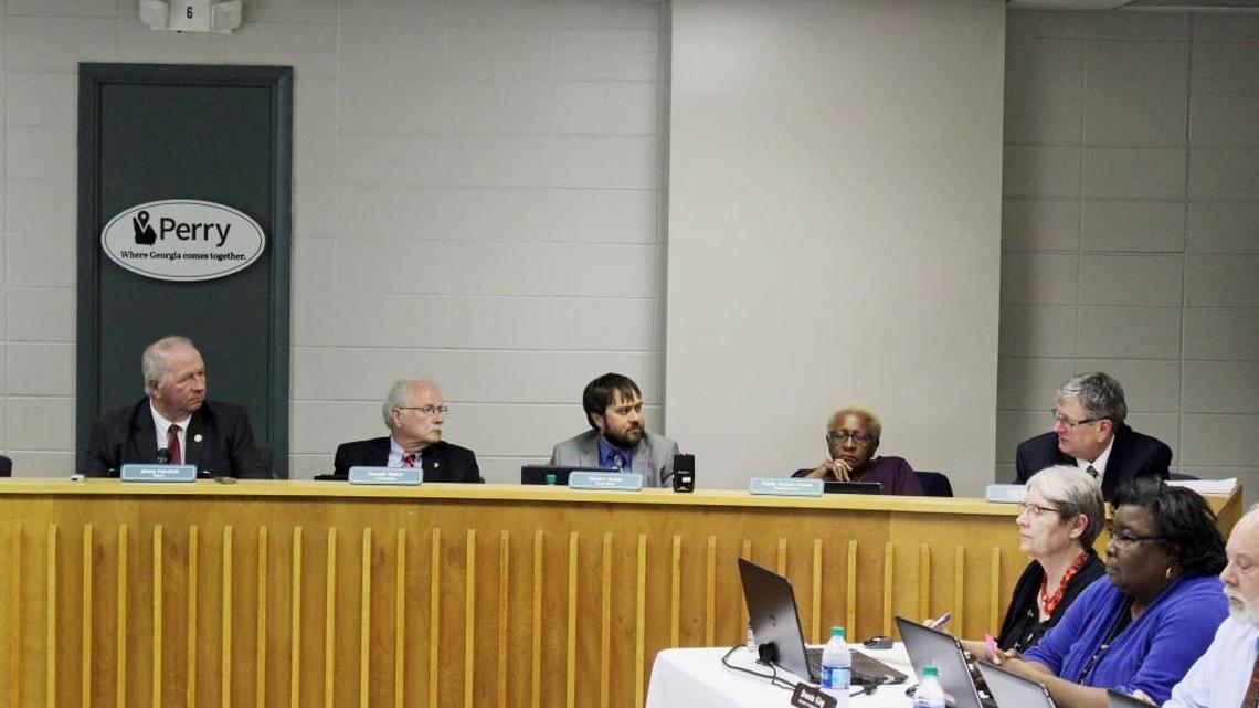 Perry City Manager Lee Gilmour, right, talks about a franchise fee at Tuesday's council meeting.