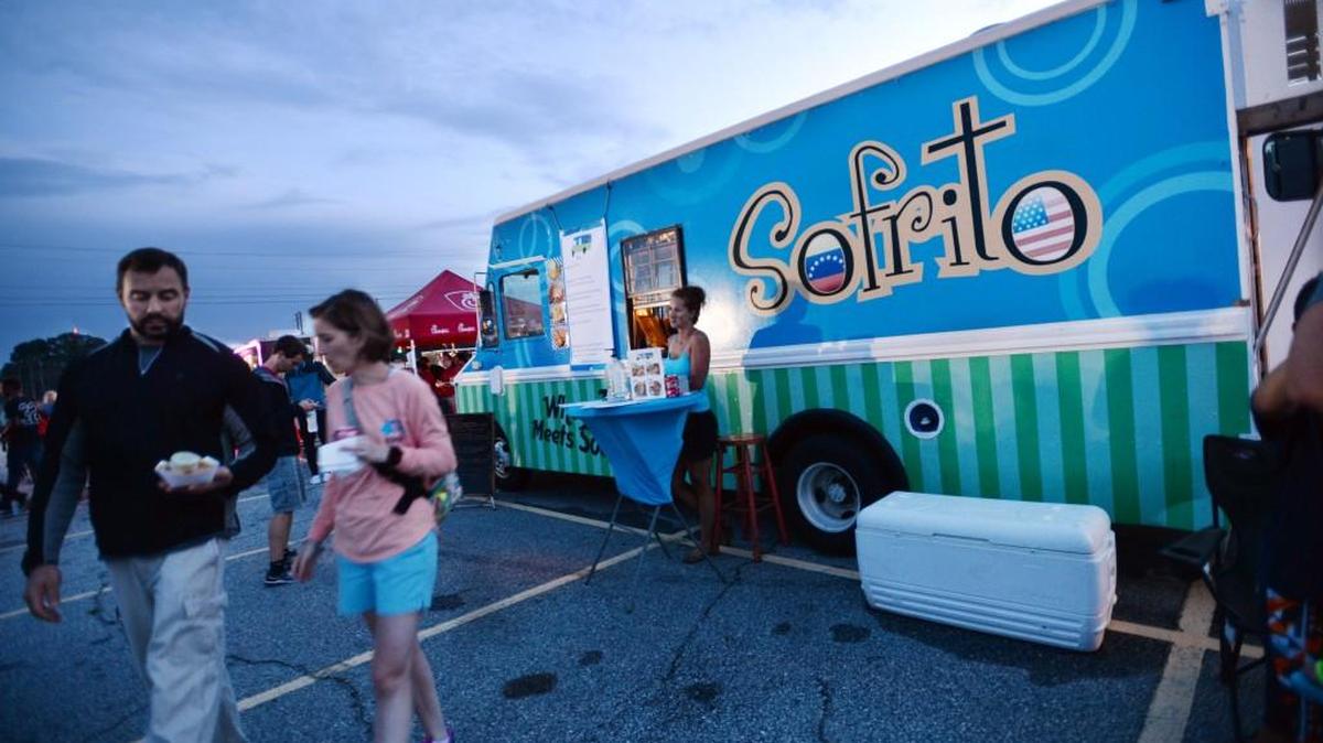 Jada Smith stands in front of her Sofrito Fusion food truck at the Independence Day Celebration on Friday.