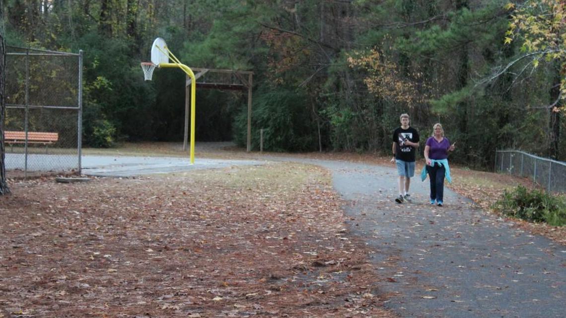 People walk along Wellston Trail into Fountain Park in Warner Robins on Tuesday. Recreation is a major part of the proposed Houston County sales tax referendum, and Fountain Park is part of the city's recreation improvement plan.