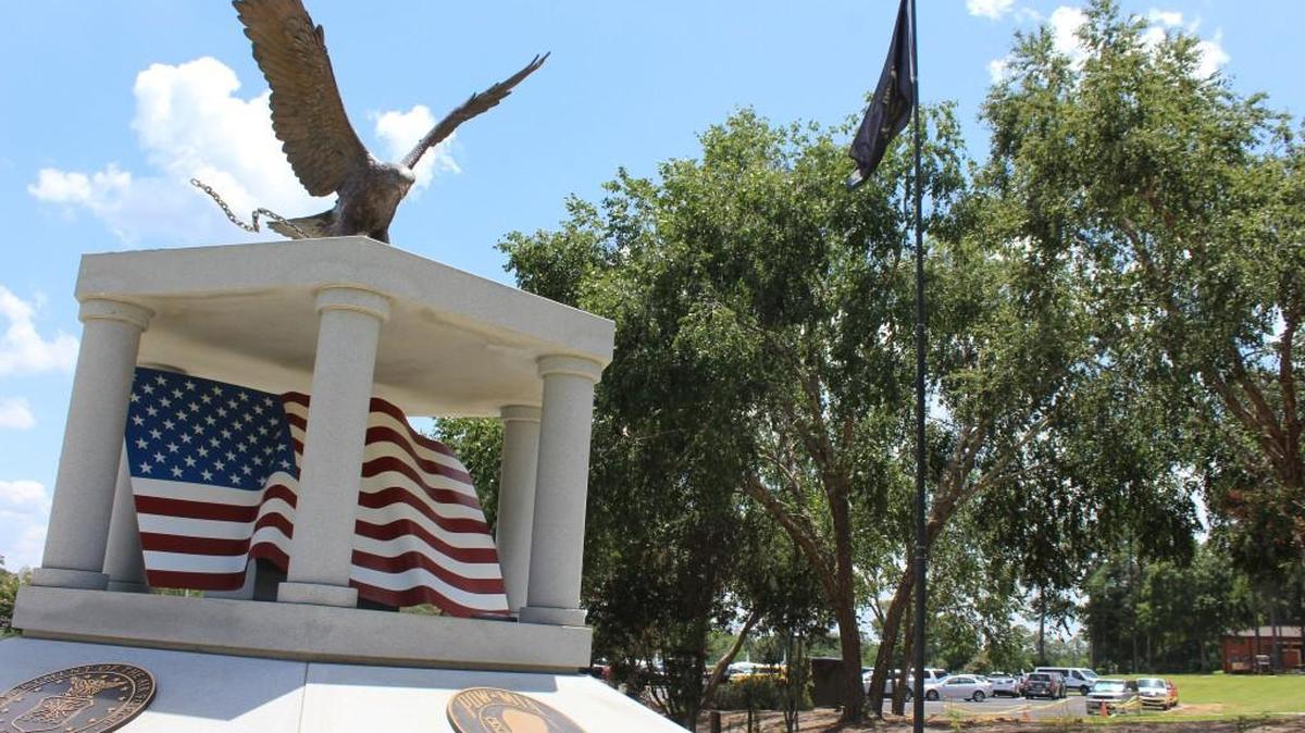 A POW/MIA flag flies over the POW/MIA monument at the Museum of Aviation. About 200 former prisoners of war have been invited to an event to be held in Warner Robins on Sept. 15.