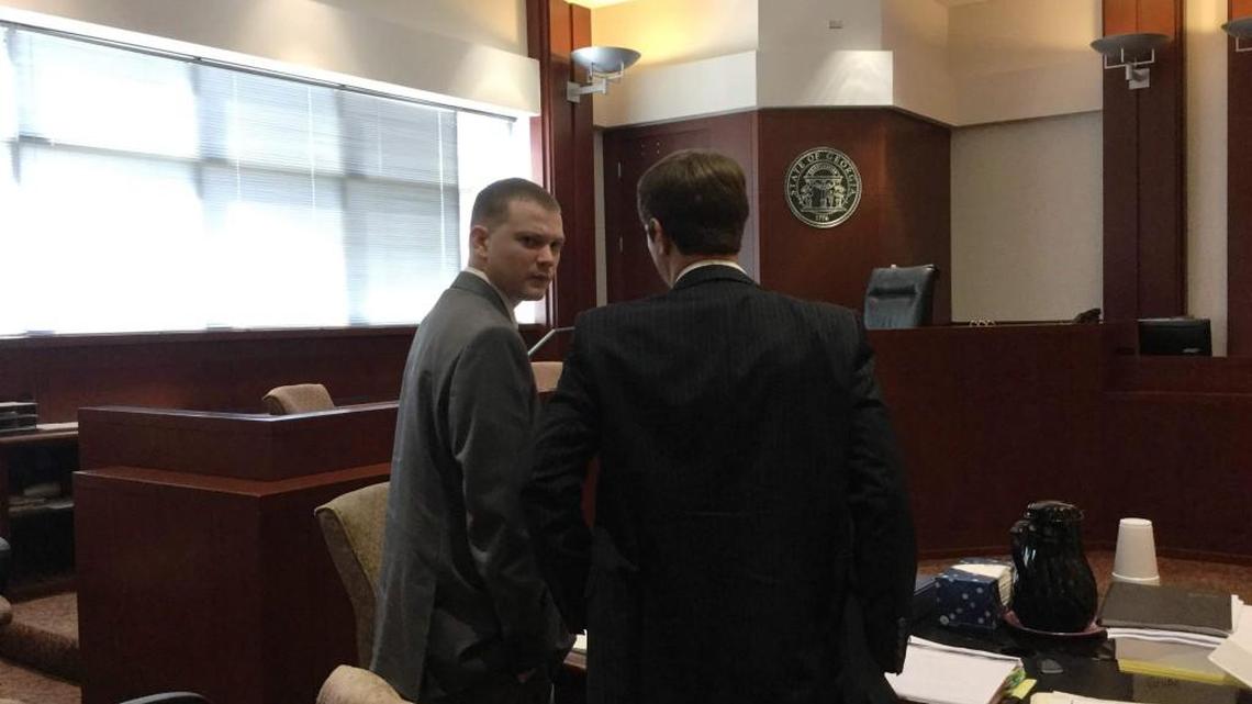 Coleman “Cole” Crouch looks back as he confers with one of his attorneys, C.J. Walker of Warner Robins, during a short break in Crouch’s murder trial in Houston County Superior Court in this Telegraph file photo.