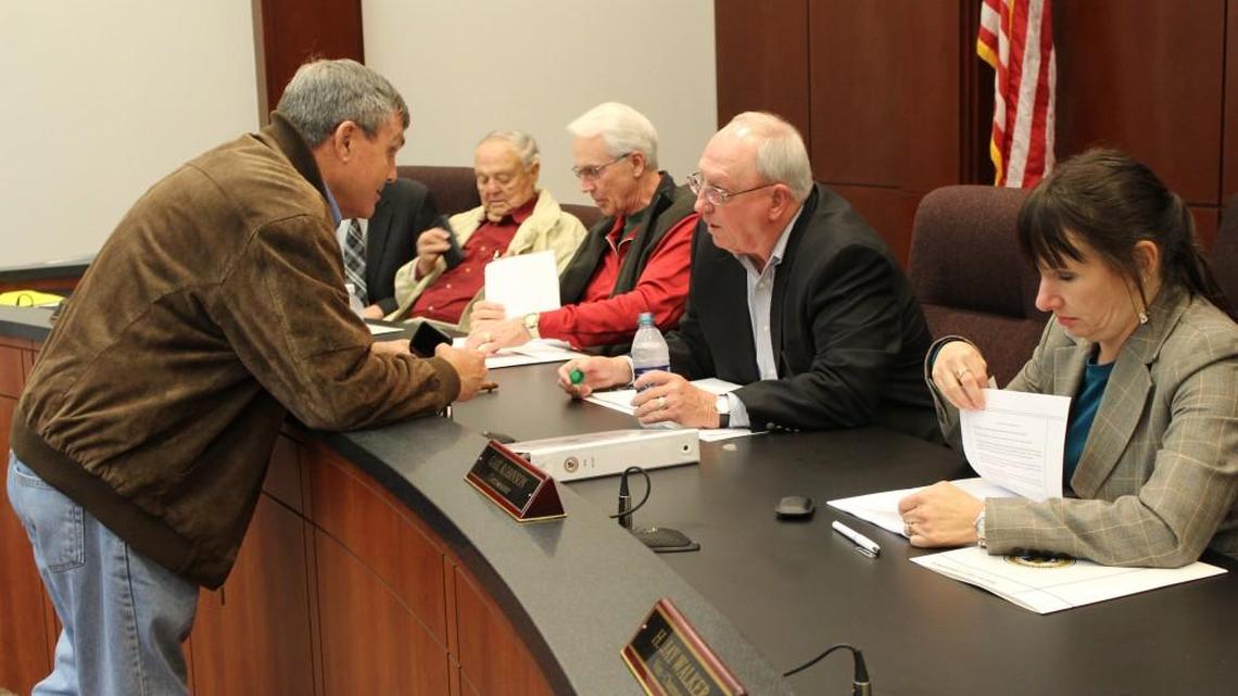 Centerville Mayor John Harley, left, speaks with Houston County Commission Chairman Tommy Stalnaker prior to a meeting Tuesday to call for a sales tax referendum.