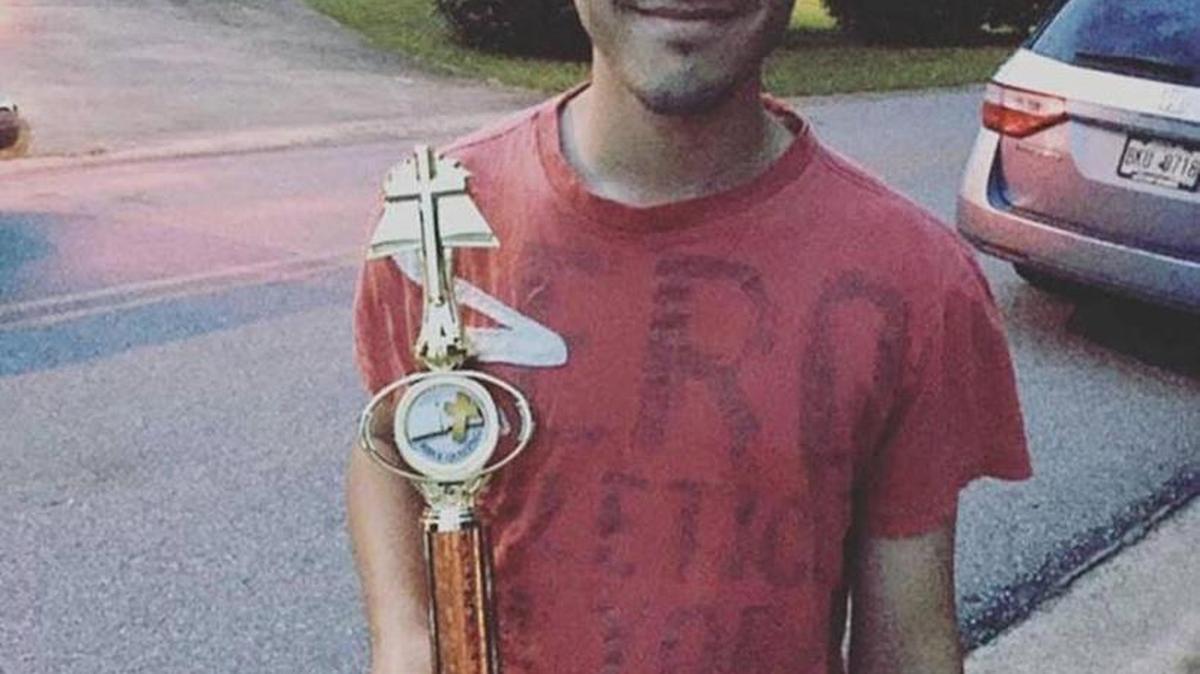 Jay Mullens holds the Bible quiz trophy he won.