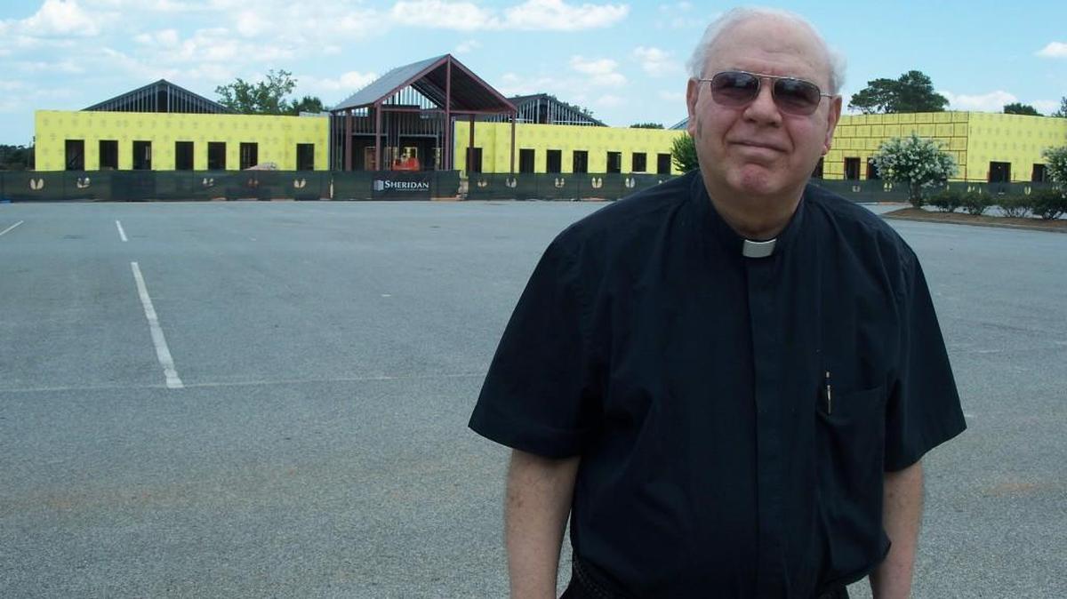 Monsignor Fred Nijem, Sacred Heart Catholic Church’s pastor, stands at the site of the church’s new $9 million multipurpose facility.