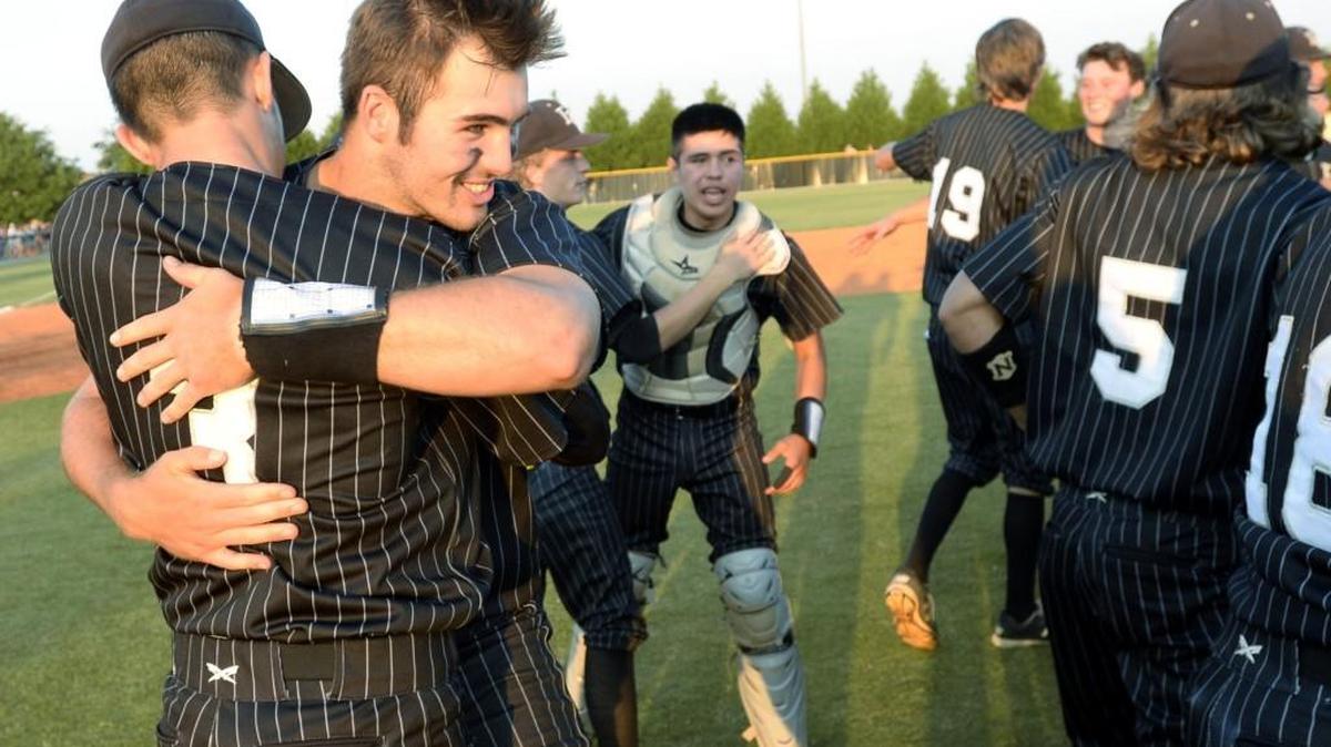 Houston County High School’s Jake Fromm (11) hugs teammate DL Hall (3) after their GHSA championship win over Loganville.