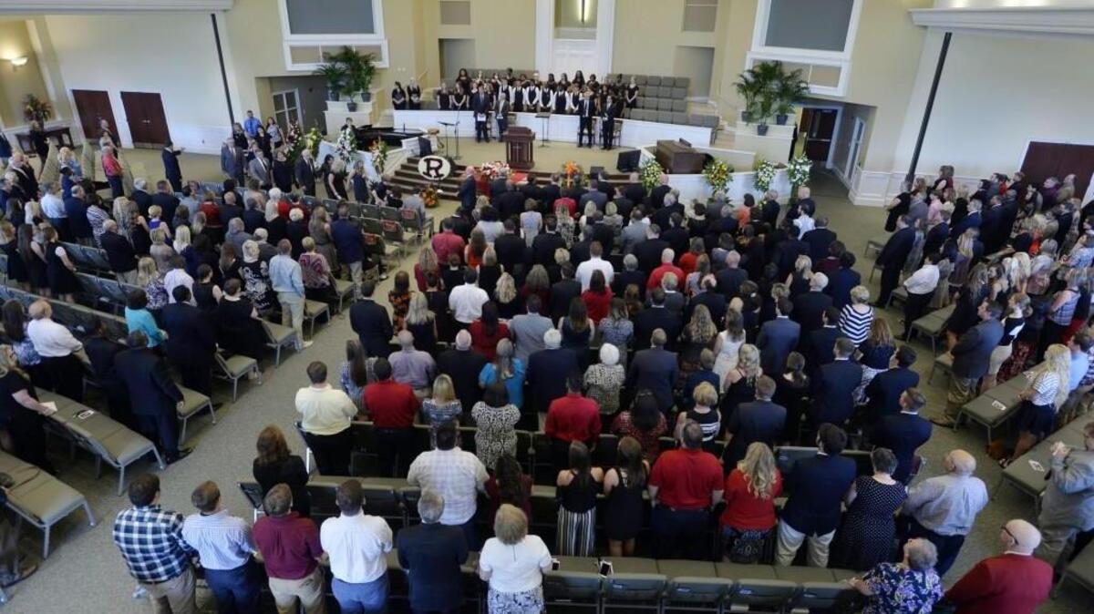 The family of the late Warner Robins High School Principal Steve Monday proceeds into the Central Baptist Church for services on Saturday.