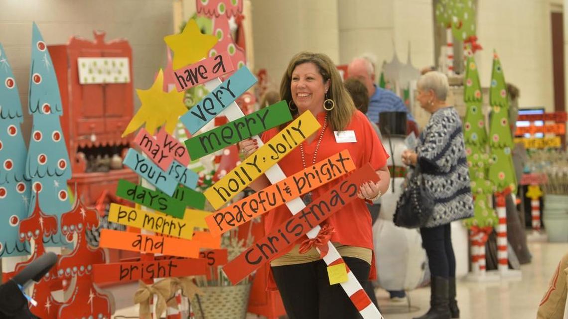 Lisa Fallaw carries a gift she found at the Mistletoe Market in 2015.