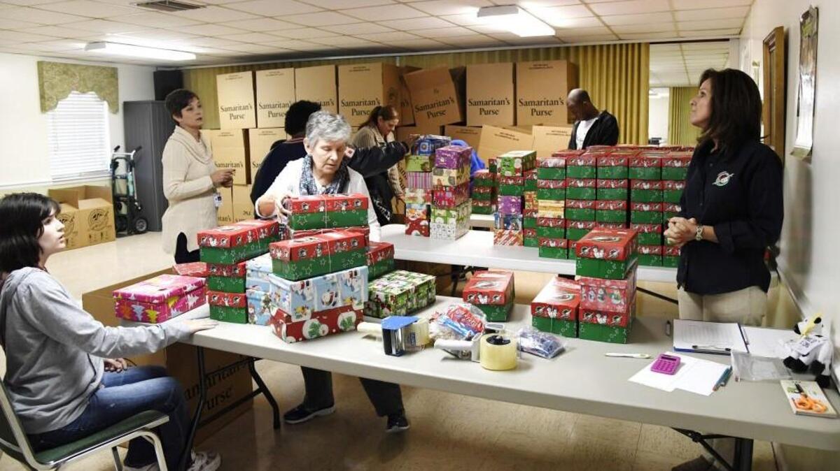 Volunteers box up shoe boxes filled with children’s toys and supplies Nov. 14 at the Operation Christmas Child drop off center at Shirley Hills Baptist Church.