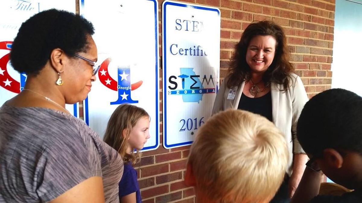 Principal Andrea McGee talks with students and teachers about projects on the front steps of Eagle Springs Elementary School. McGee has been named Georgia’s 2016 National Distinguished Principal.