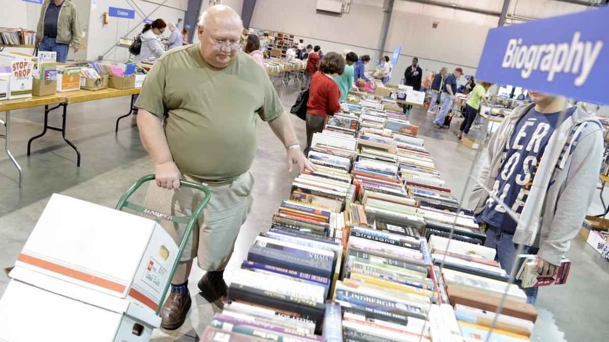 B.K. Lilja looks through a selection of biography books during the 2014 Houston County Friends of the Library Old Book Sale.