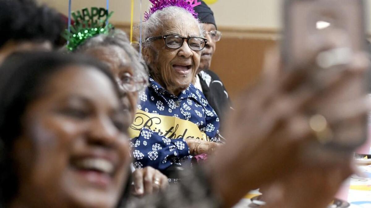 Thelma Roberts, center, has her picture taken by her niece Avril Cobb during Roberts’ 107th birthday celebration Nov. 1 last November at Warner Robins Rehabilitation Center in this Telegraph file photo.