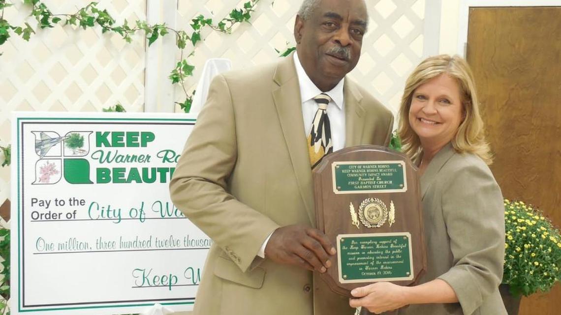 On behalf of First Baptist Church-Garmon Street, Houston Porter accepted the Community Impact Award from Debra Jones, executive director of Keep Warner Robins Beautiful.