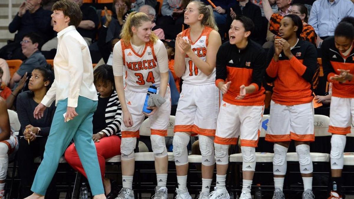 Mercer coach Susie Gardner, left, and her team cheer their defense during fourth quarter action as the Bears pulled away from Samford for their 20th straight win February 10. Mercer beat Samford, 48-45.