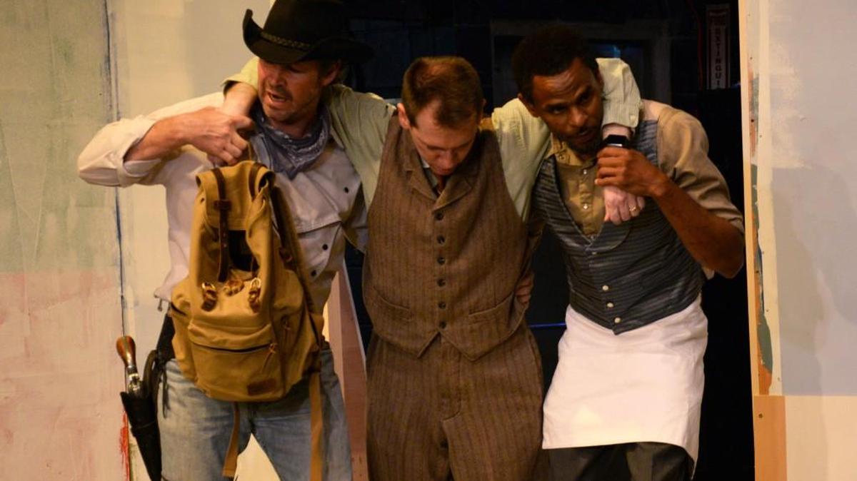 Ransom Foster, played by Jim Franz, is carried in by Bert Barricune, left, and Jim Mosten, played by Paul King and Driscoll Clemons, in a dress rehearsal of the Warner Robins Little Theatre production of “The Man Who Shot Liberty Valance.”